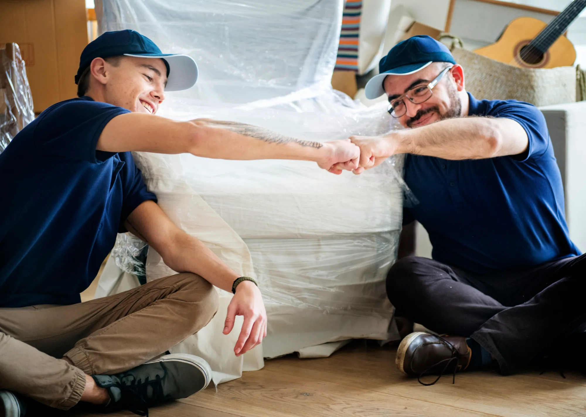 movers bump fists after wrapping furniture 2026 01 07 23 24 58 utc